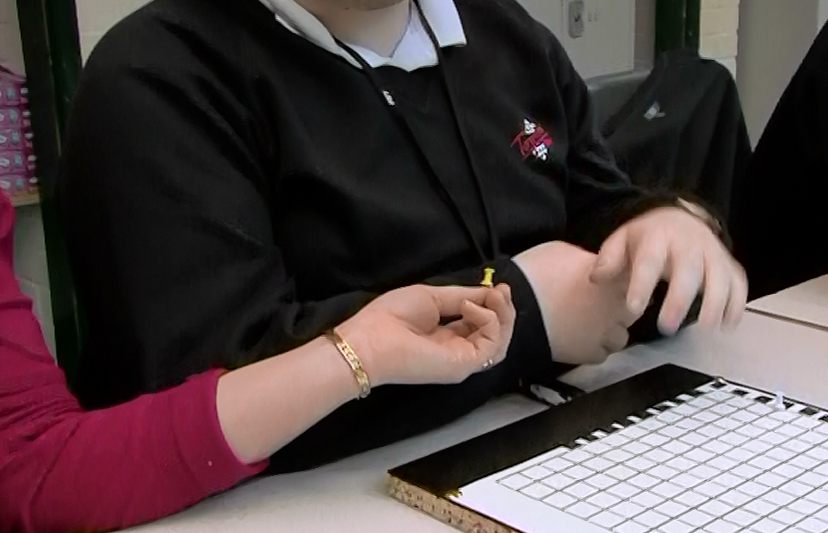 Assistant passing a pin to a VI candidate constructing a graph