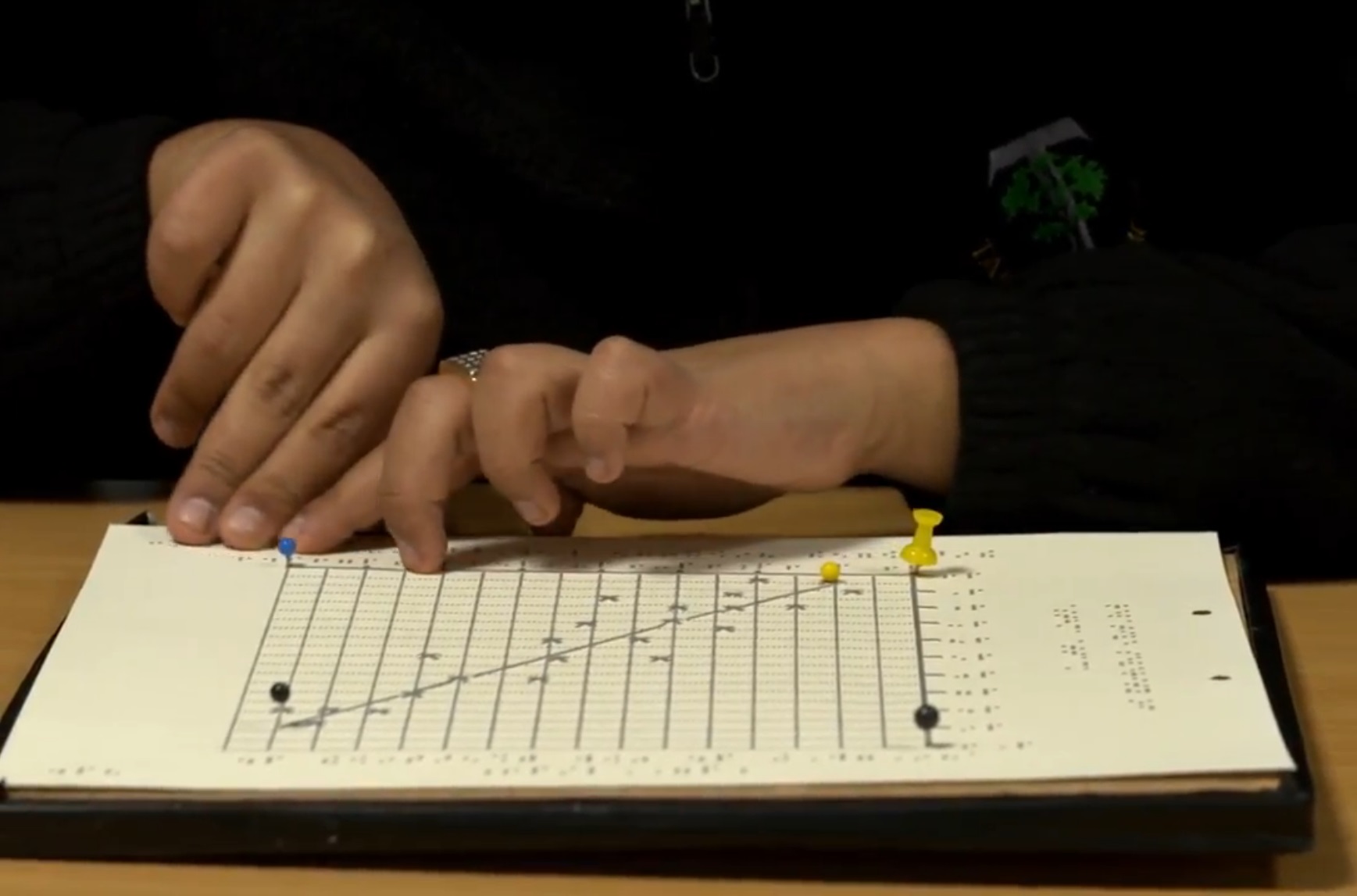 Student reading a braille graph